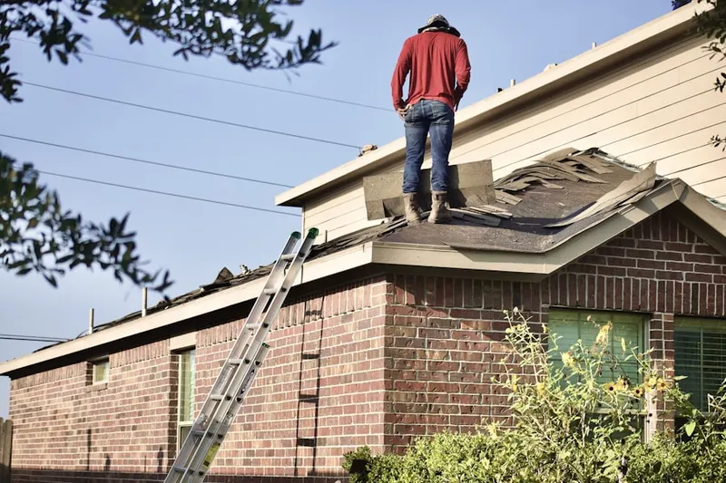 Professional roofer working on a residential roof in West Hampton Dunes